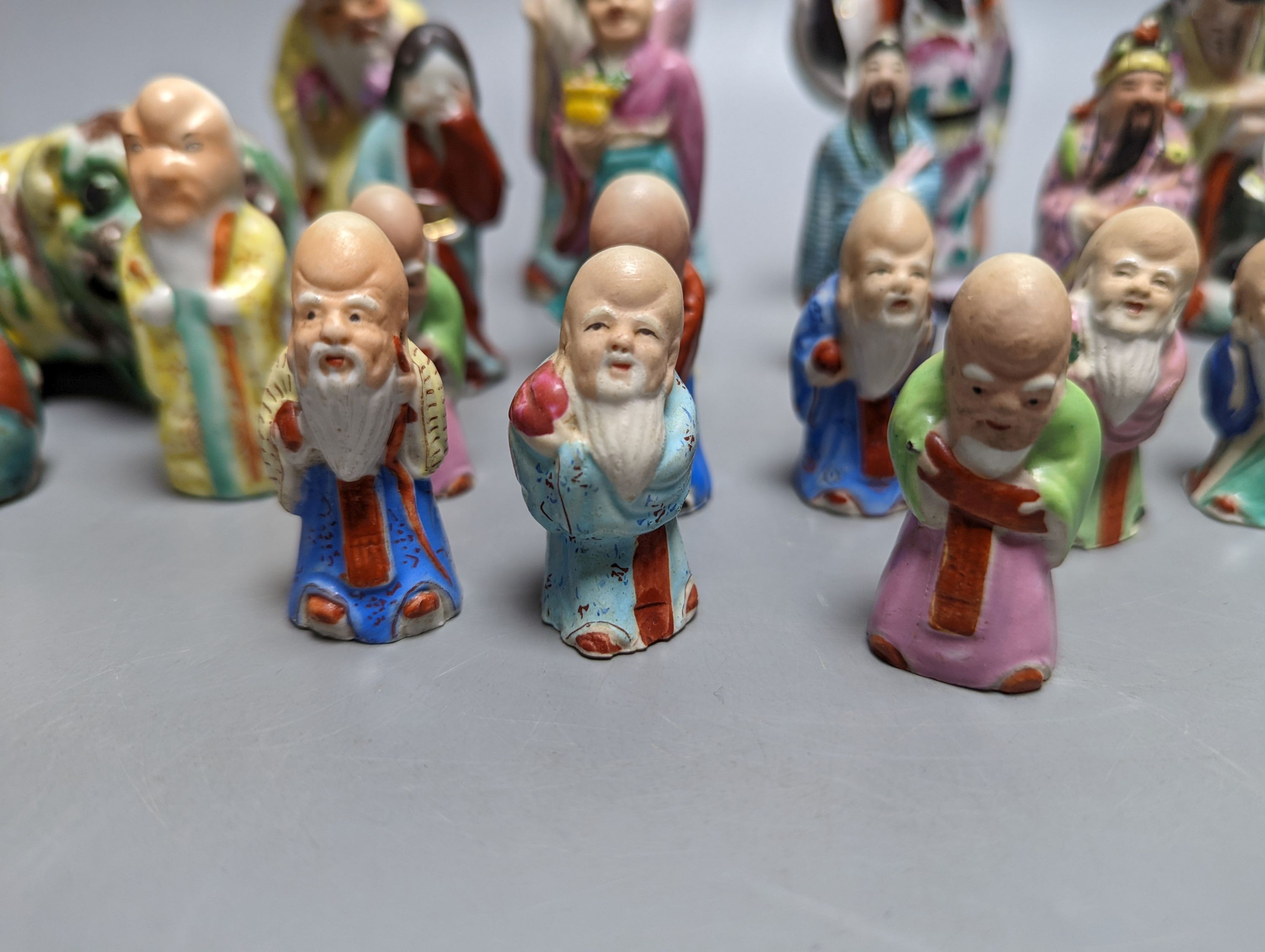 A collection of Chinese enamelled porcelain miniature figurines, including a 19th century Chinese sancai enamelled biscuit figure of a beast, 9cm